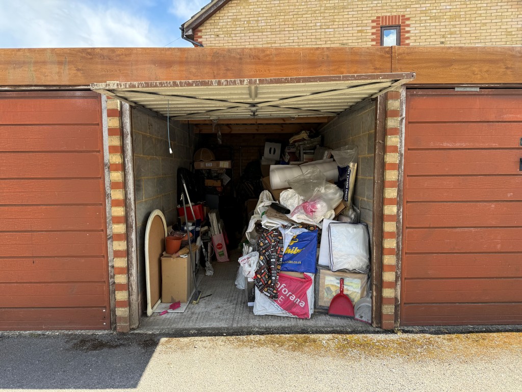 Lot: 128 - TWO-BEDROOM FLAT WITH GARAGE IN NEED OF UPDATING - Garage number 7 with open door